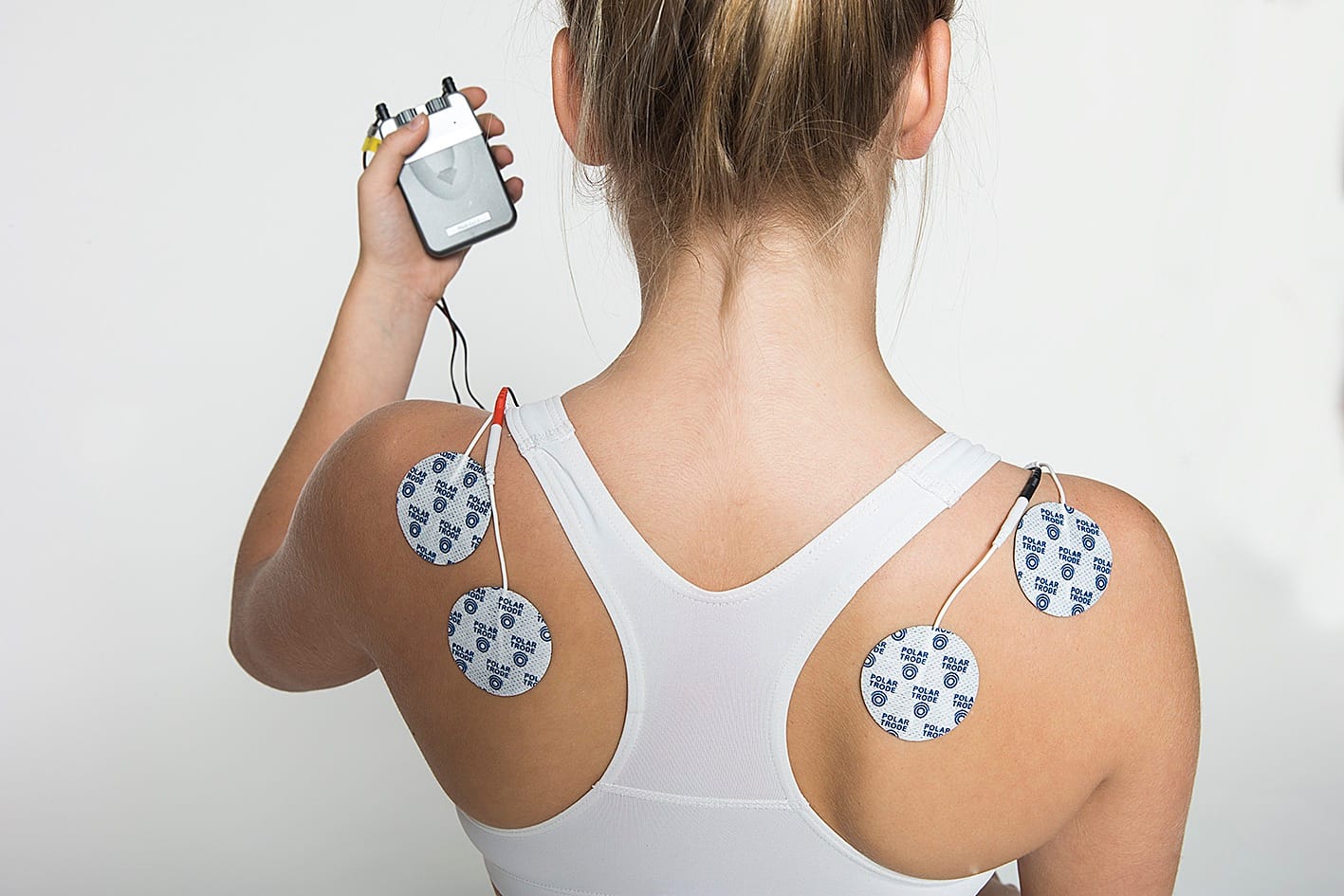 Polar Trode electrodes applied to patient's lower back with TENS machine